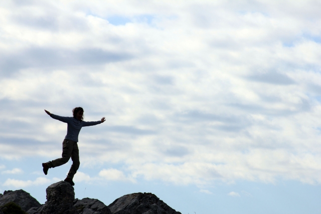  woman climbing a rock 